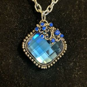 Beautiful blue faceted gem with wire and crystals